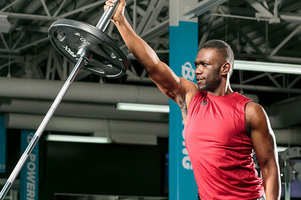 Aaron keel performing shoulder exercises in the gym