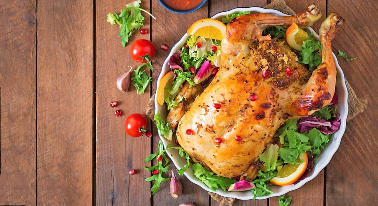 Cooked and seasoned chicken on a plate surrounded by salad