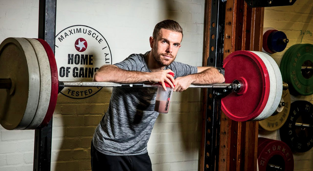 jordan henderson stood at the squat rack with a protein shake