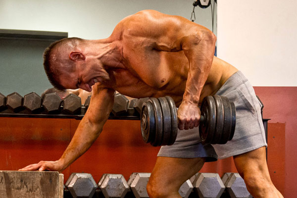 chad shaw in the gym performing a single arm row