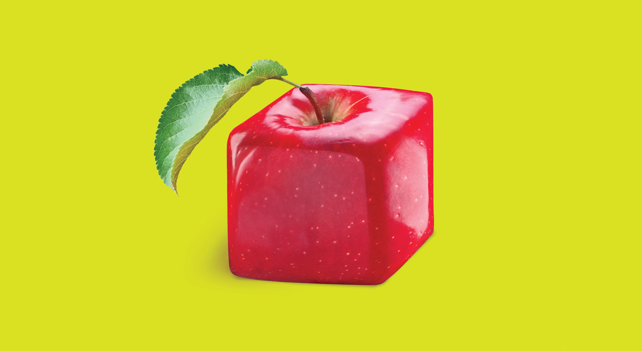 an apple in the shape of a cube on a greeny yellow background