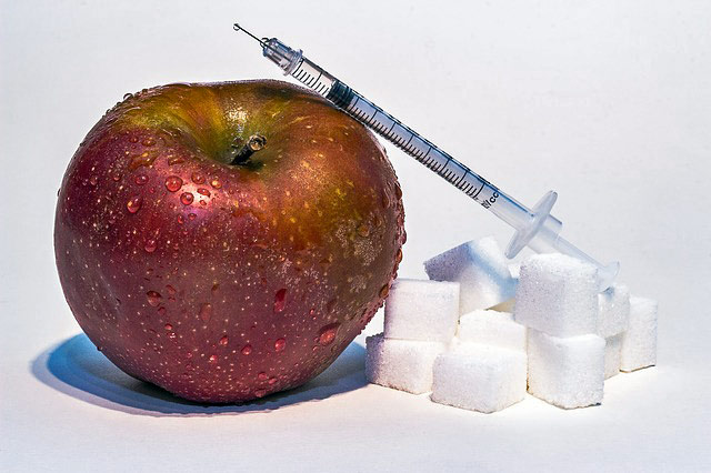 an apple sugar cubes and needle