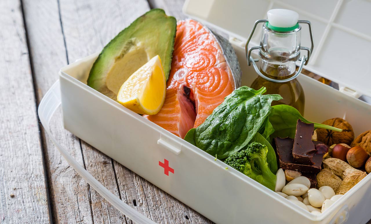 small grey box filled with fruit fish and vegetables