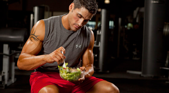 vinny russo eating a salad bowl in a gym