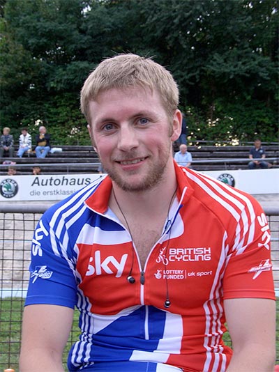 james kenny smiling at the camera with his british cycling jersey on