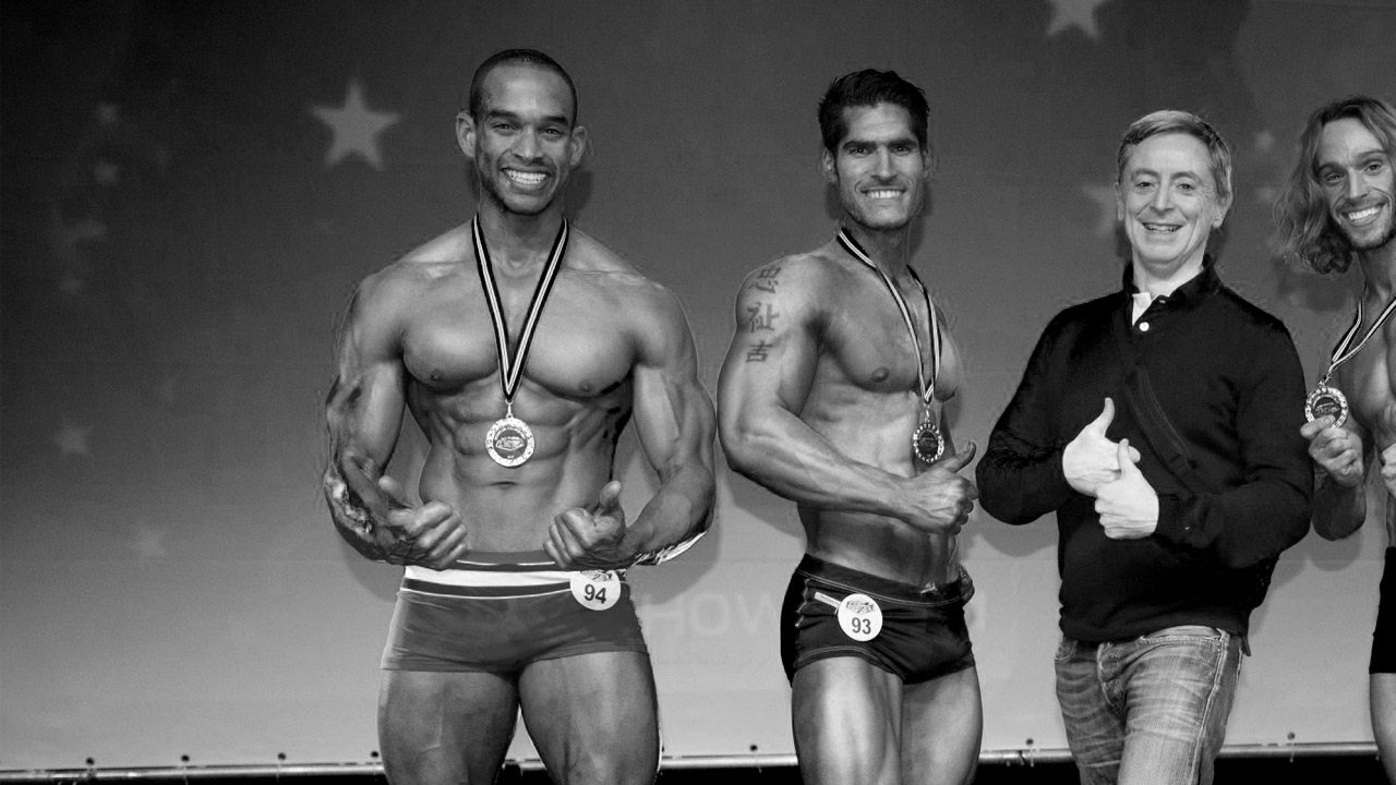 Jason Dwarika on stage with his medal
