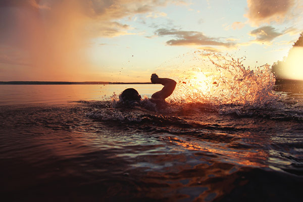 man swimming in the sea