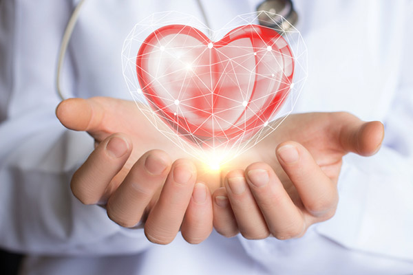 geometric heart floating above someones hands