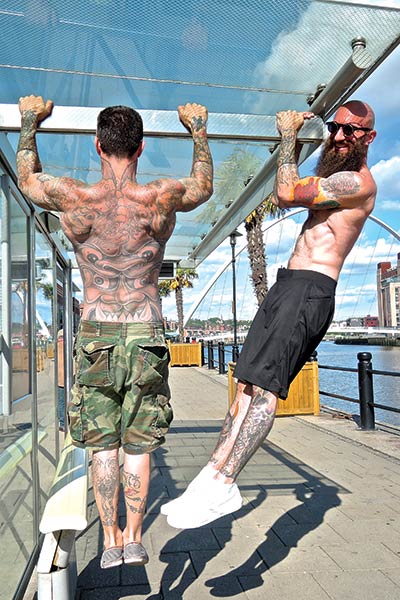 the kavadlo brothers doing calisthenics on a bus stop in Newcastle Upon Tyne