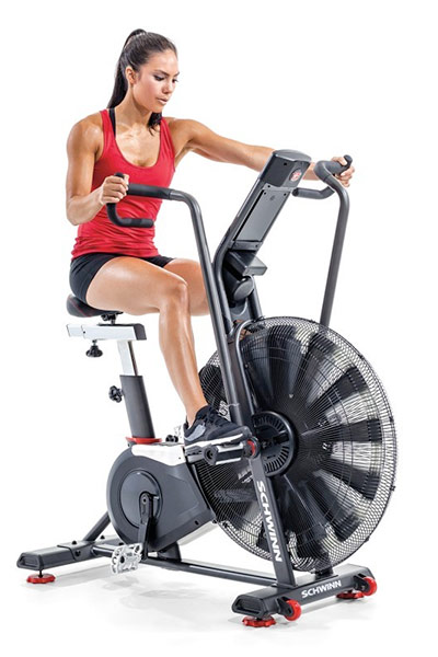 fit woman riding an air bike airdyne ad8