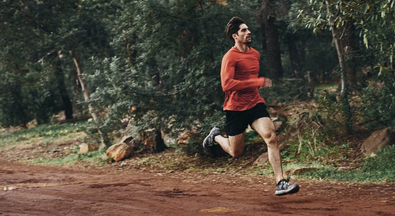 man running down a dirt track