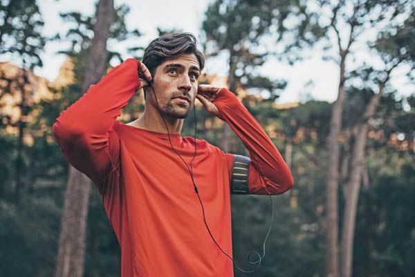 man in the woods listening to music