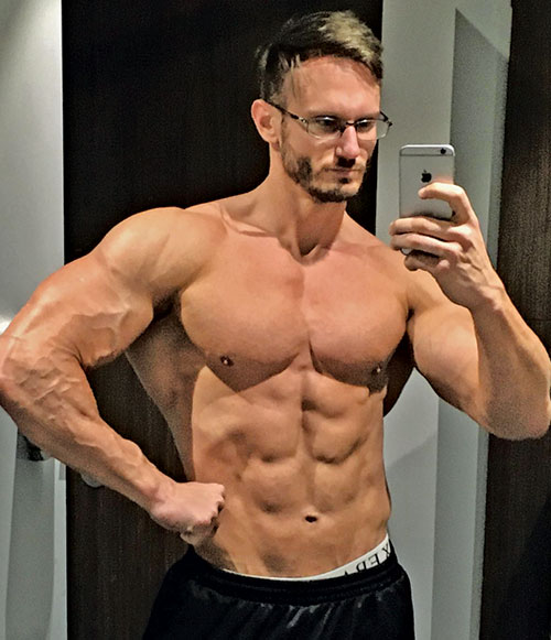 muscular man flexing muscles in mirror
