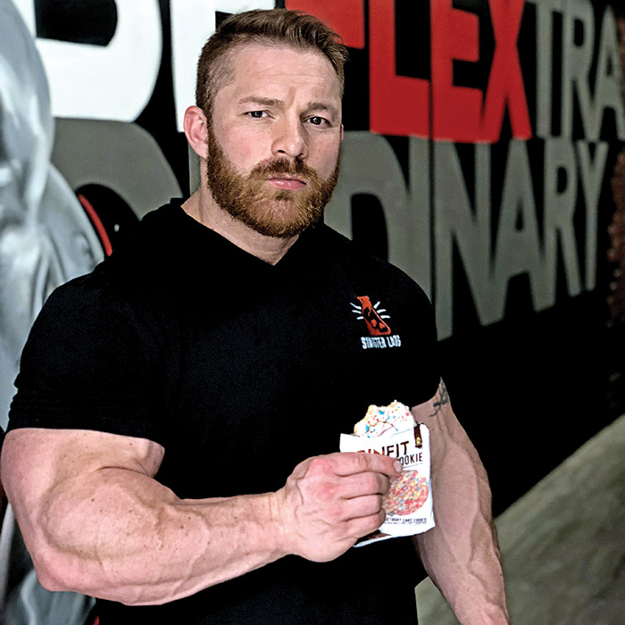 flex lewis eating a sinfit cookie