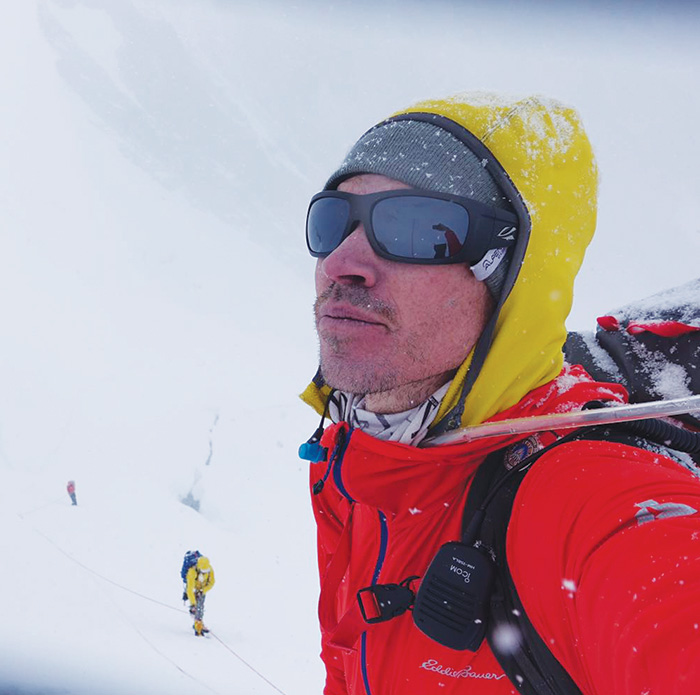 adrian ballinger in the mountains surrounded by snow