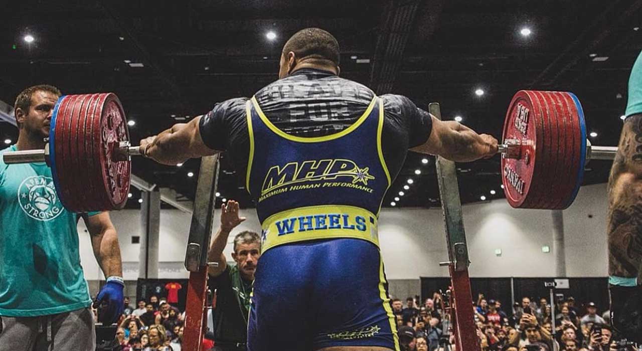 Larry Wheels infront of the squat rack waiting to perform