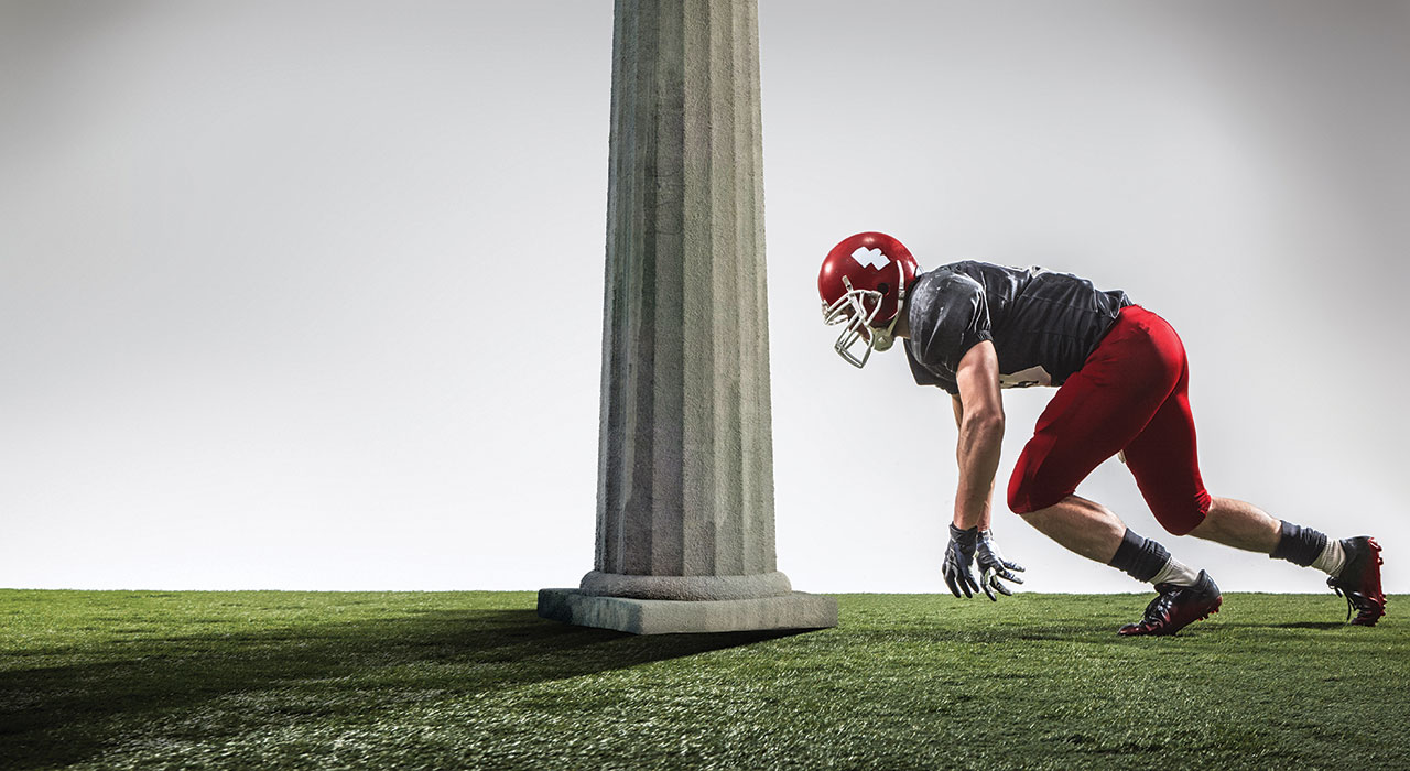 american footballer about to tackle a pillar