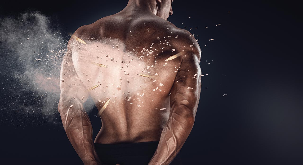 a muscular man tensing his back muscles
