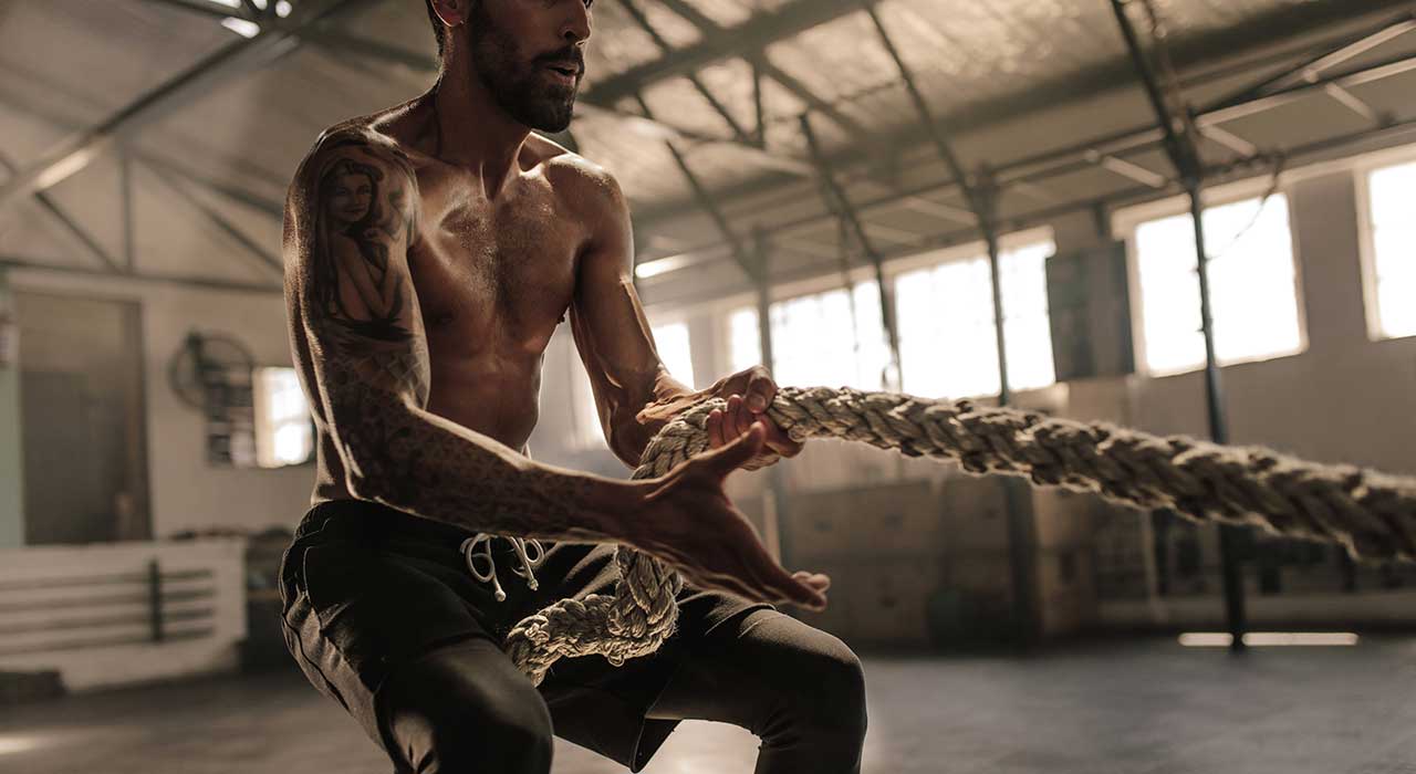 muscular man pulling a rope