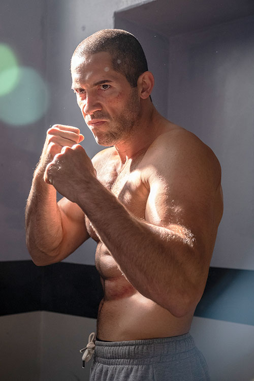 scott adkins with fists clenched and topless