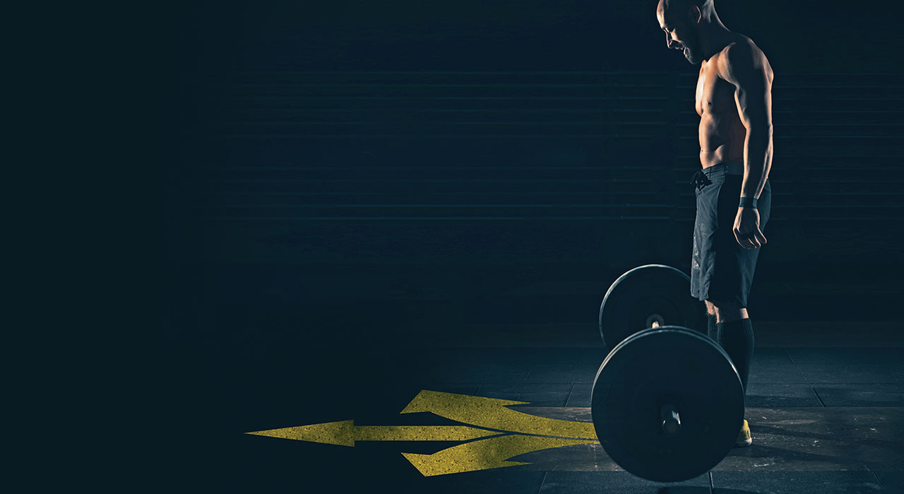 man stood in front of a barbell