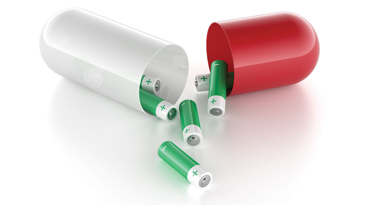 a pill open in tow pieces with batteries coming out