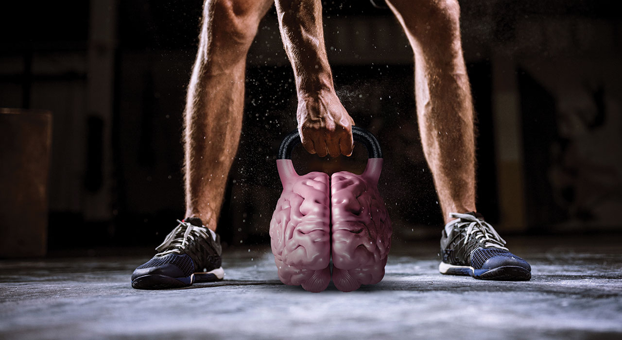 man holding a kettlebell in the shape of a brain