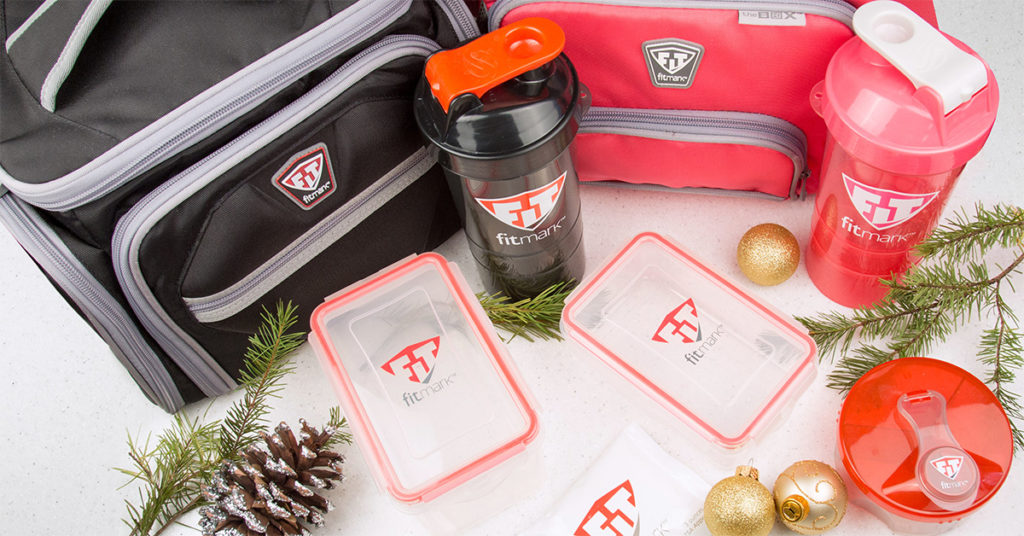fitmark bags fitmark tupperware and fitmark shaker with christmas decoration around them
