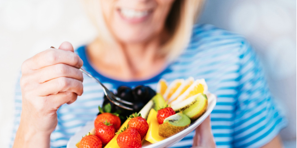 senior woman eating fruit