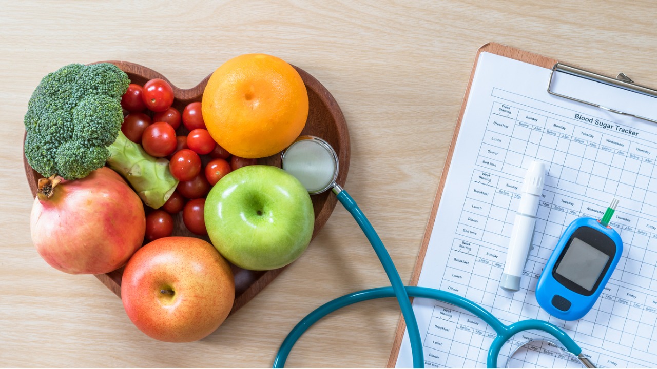 heart shaped bowl with fruit in next to a stethoscope