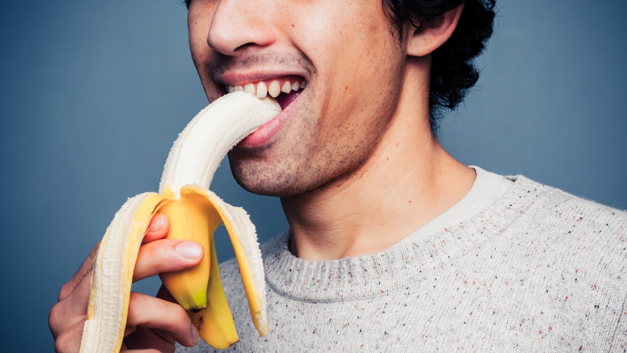 man eating banana