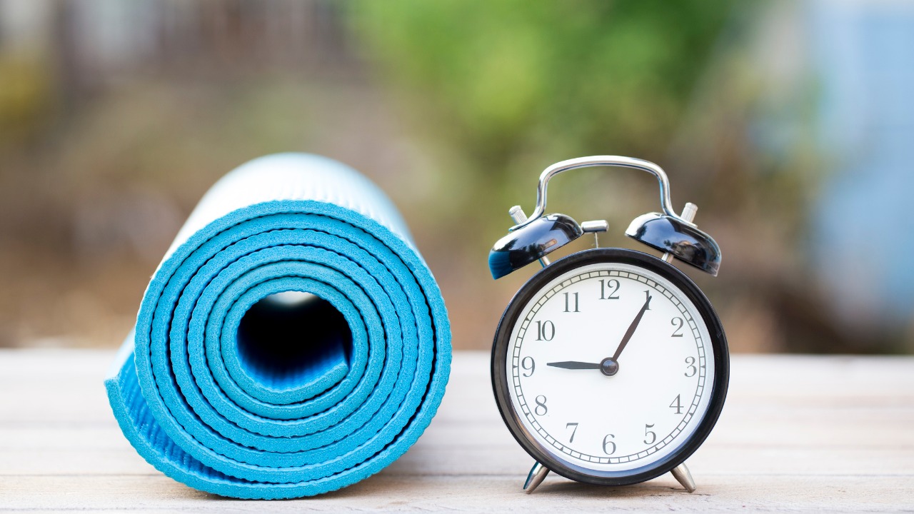 alarm clock next to a workout mat