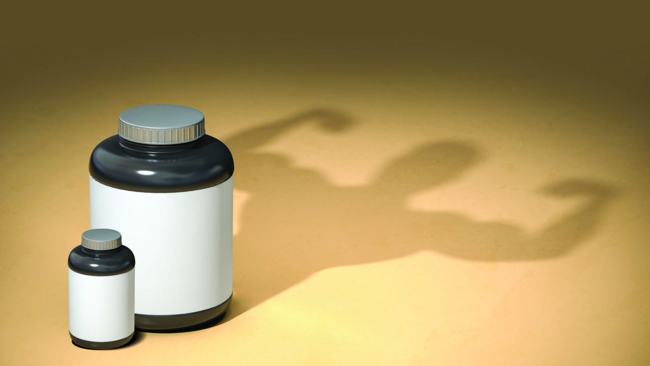 supplements and shadow of man flexing muscles